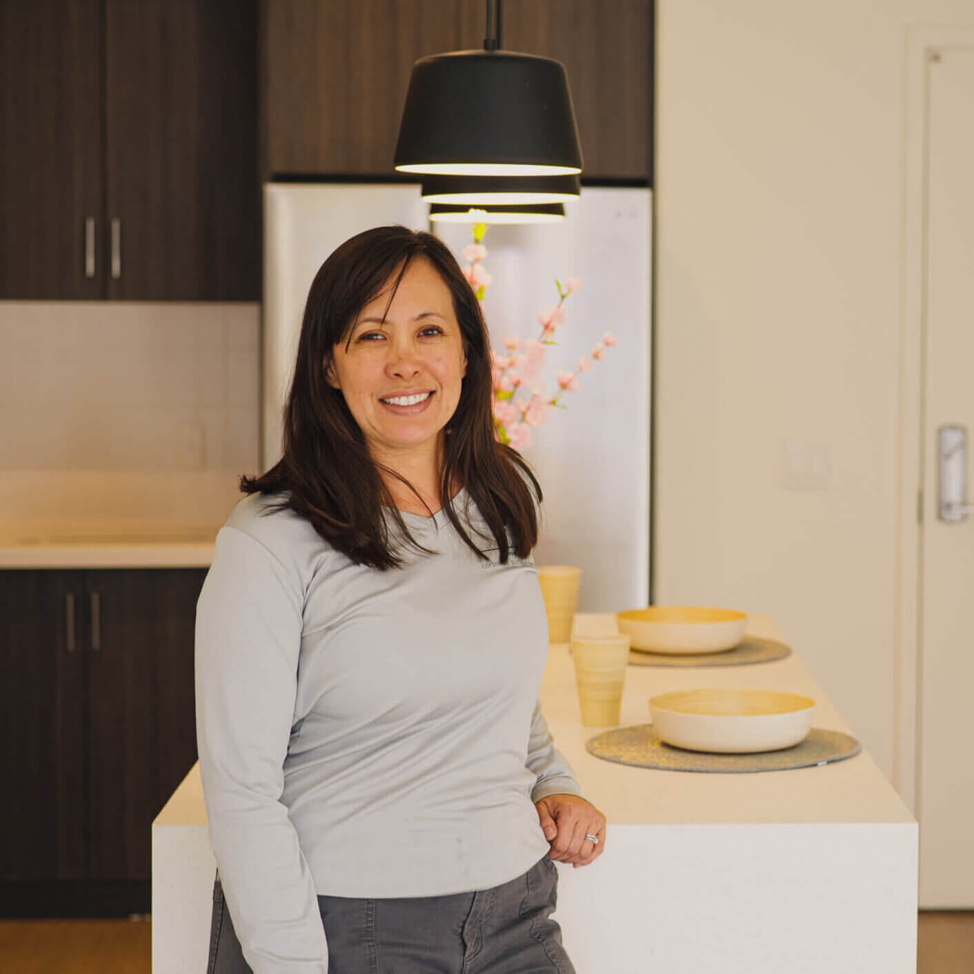 Founder of Concepts: Corporate Suites, a woman is standing in the dining room of a furnished apartment in Tucson